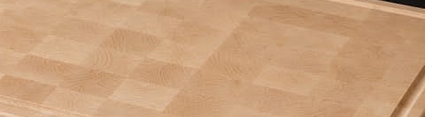 The end-grain surface of a finished maple board: a pale cream chequer, almost without visible grain.